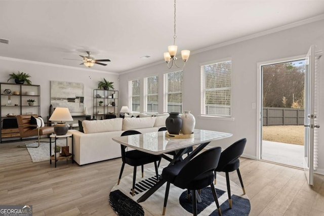 dining area with ornamental molding, light wood-type flooring, and ceiling fan with notable chandelier