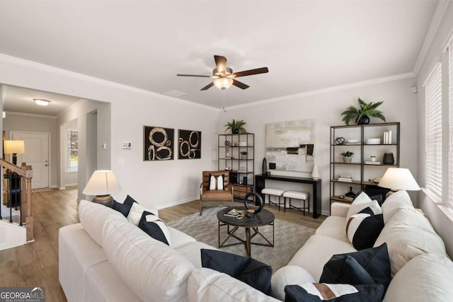 living room featuring ornamental molding, ceiling fan, and hardwood / wood-style floors