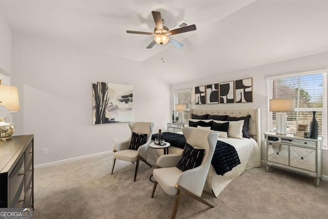 carpeted bedroom with ceiling fan and vaulted ceiling