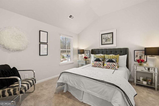 bedroom with vaulted ceiling and light colored carpet