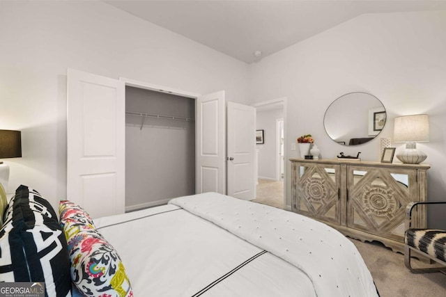 bedroom with lofted ceiling, a closet, and carpet flooring