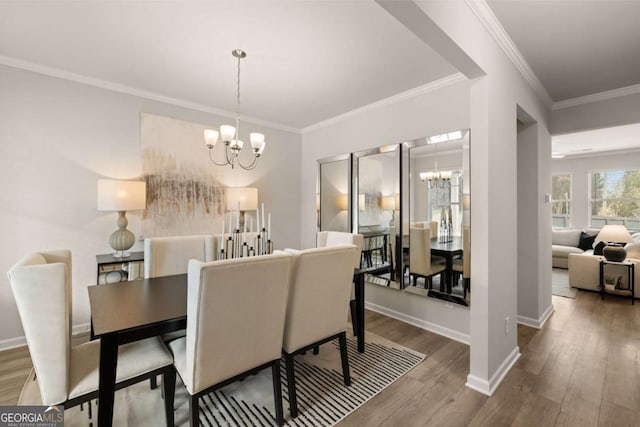 dining room featuring an inviting chandelier, crown molding, and hardwood / wood-style flooring