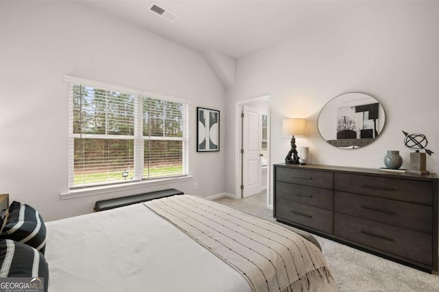 carpeted bedroom with vaulted ceiling