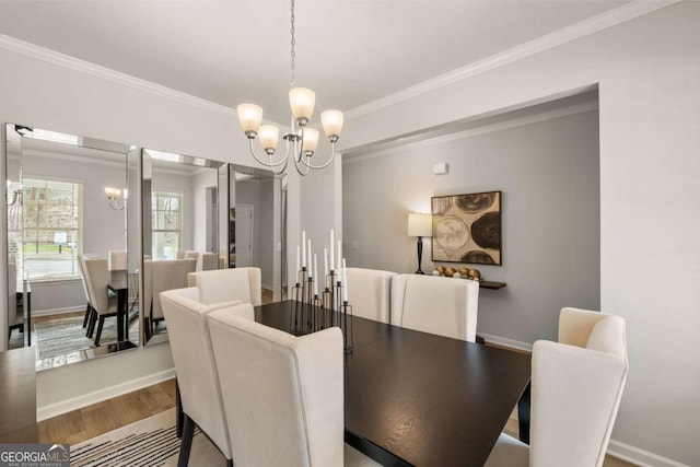 dining space featuring a chandelier, ornamental molding, and hardwood / wood-style flooring