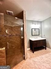 bathroom with vanity and a shower