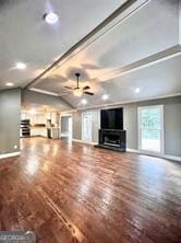 unfurnished living room featuring hardwood / wood-style flooring and ceiling fan