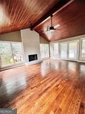 unfurnished living room featuring ceiling fan, wooden ceiling, wood-type flooring, and vaulted ceiling with beams