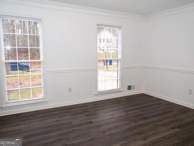 spare room with dark wood-type flooring and ornamental molding