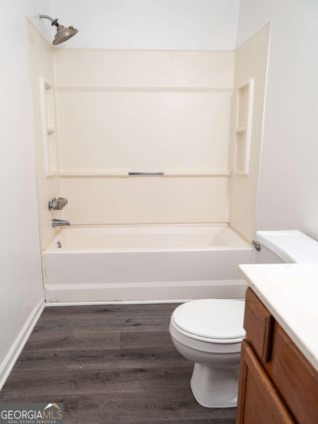 full bathroom with toilet, tub / shower combination, wood-type flooring, and vanity