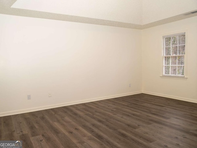 unfurnished room with dark hardwood / wood-style floors