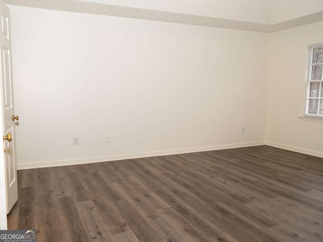 empty room with dark wood-type flooring