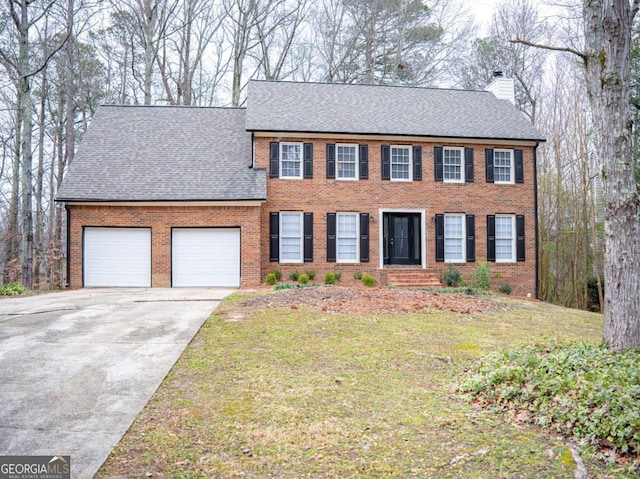 colonial house with a front lawn and a garage