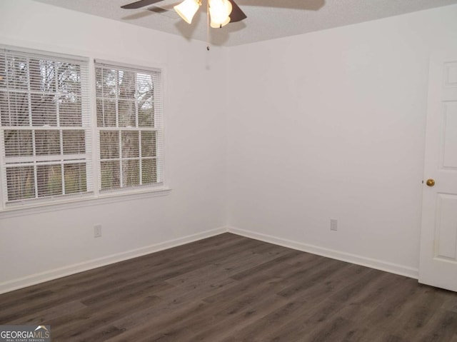 unfurnished room with a textured ceiling, ceiling fan, and dark hardwood / wood-style flooring