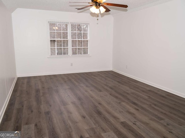 unfurnished room with a textured ceiling, ceiling fan, and dark hardwood / wood-style flooring