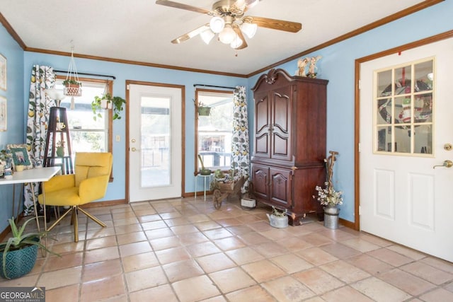 entrance foyer with ornamental molding, ceiling fan, and light tile patterned floors