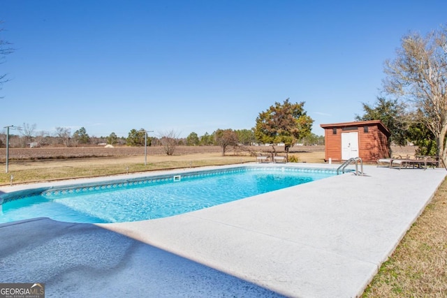 view of pool with a patio and a storage unit