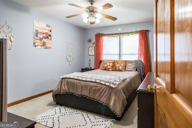 carpeted bedroom featuring a textured ceiling and ceiling fan