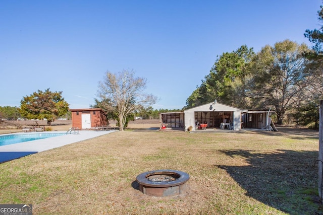 view of yard with a fire pit and a storage unit