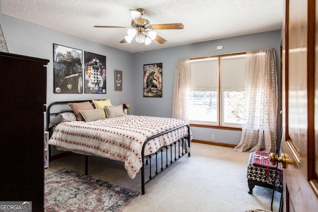 carpeted bedroom with a textured ceiling and ceiling fan