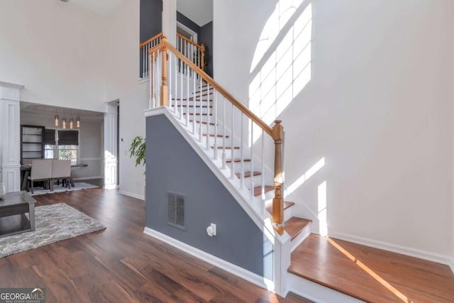 stairway with hardwood / wood-style floors