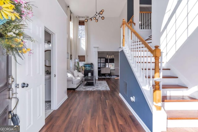 foyer entrance featuring an inviting chandelier and dark hardwood / wood-style floors