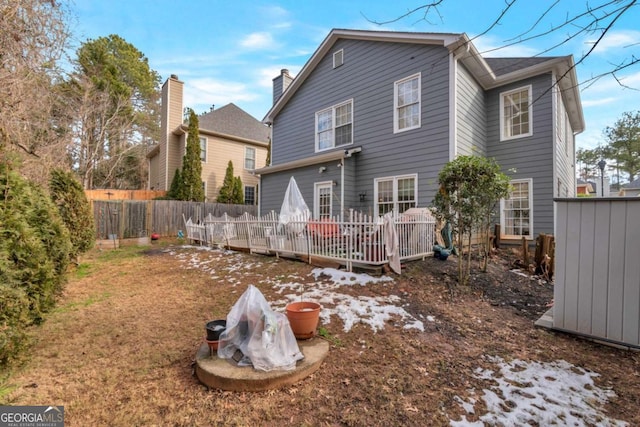 rear view of property featuring a deck