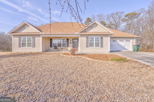 single story home featuring a porch and a garage