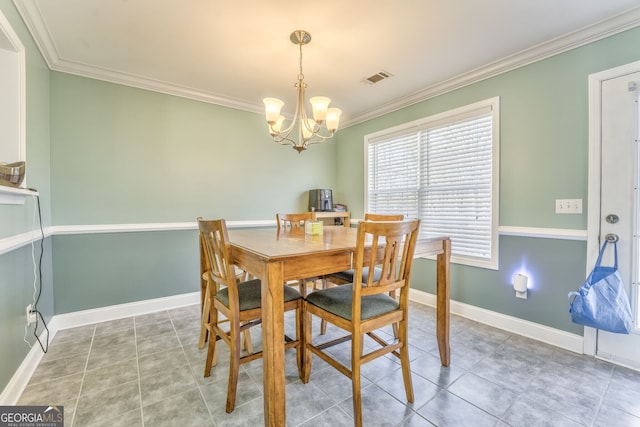 dining room featuring tile patterned flooring, a chandelier, and crown molding