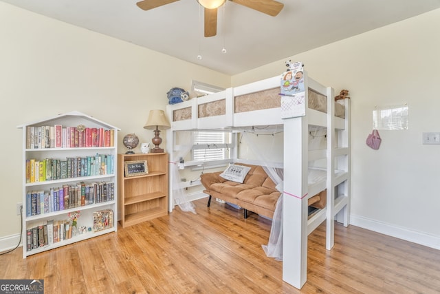 bedroom with ceiling fan and hardwood / wood-style floors