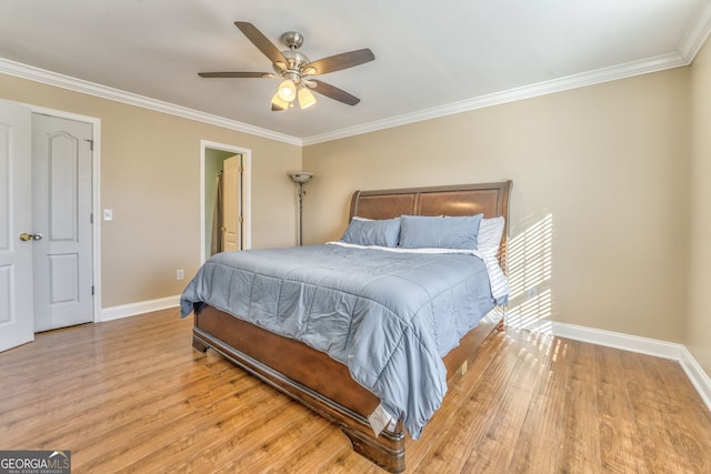 bedroom featuring ceiling fan, light hardwood / wood-style floors, and crown molding