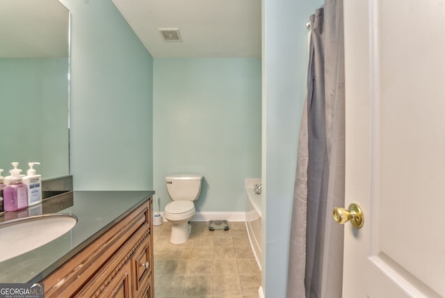 bathroom featuring toilet, a washtub, and vanity