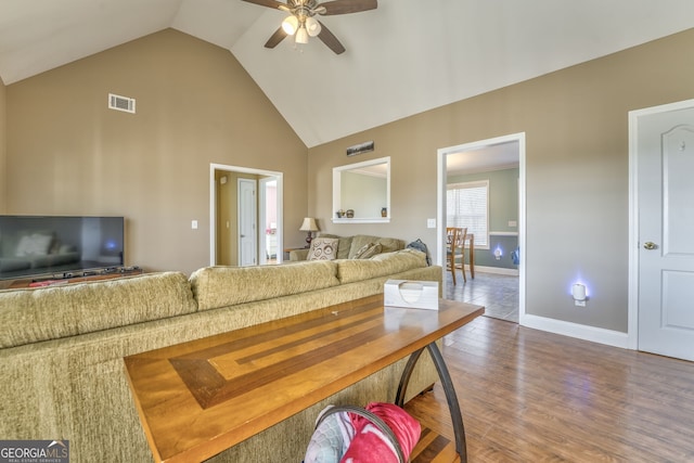 living room with vaulted ceiling, hardwood / wood-style flooring, and ceiling fan