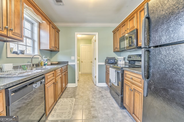 kitchen featuring sink, light tile patterned floors, black appliances, and crown molding