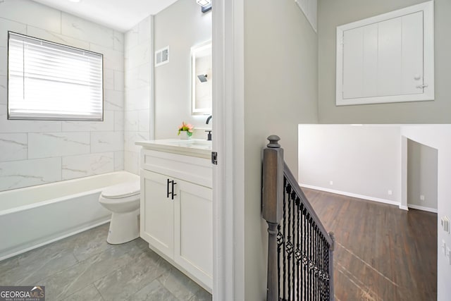 full bathroom featuring toilet, vanity, and tiled shower / bath