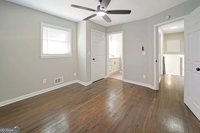 unfurnished bedroom with ensuite bath, ceiling fan, and dark hardwood / wood-style floors