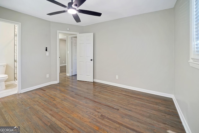 unfurnished bedroom with ensuite bathroom, ceiling fan, and dark hardwood / wood-style floors