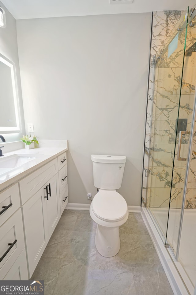 bathroom featuring an enclosed shower, vanity, and toilet