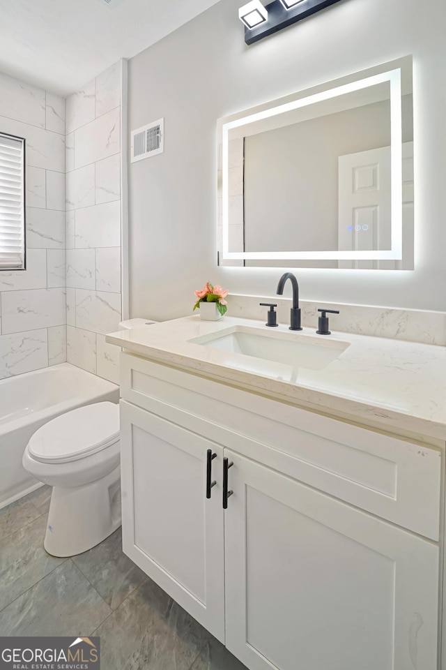 full bathroom with tiled shower / bath combo, vanity, and toilet