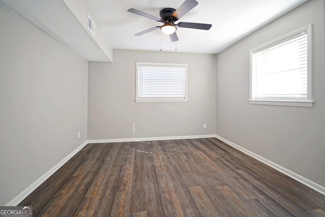 spare room featuring ceiling fan and dark wood-type flooring