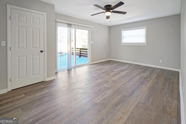 spare room with dark hardwood / wood-style flooring and ceiling fan