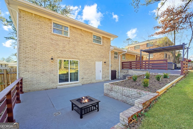 rear view of property featuring an outdoor fire pit, a patio, and a pergola