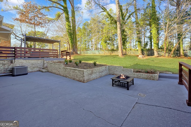 view of patio featuring central air condition unit and a fire pit