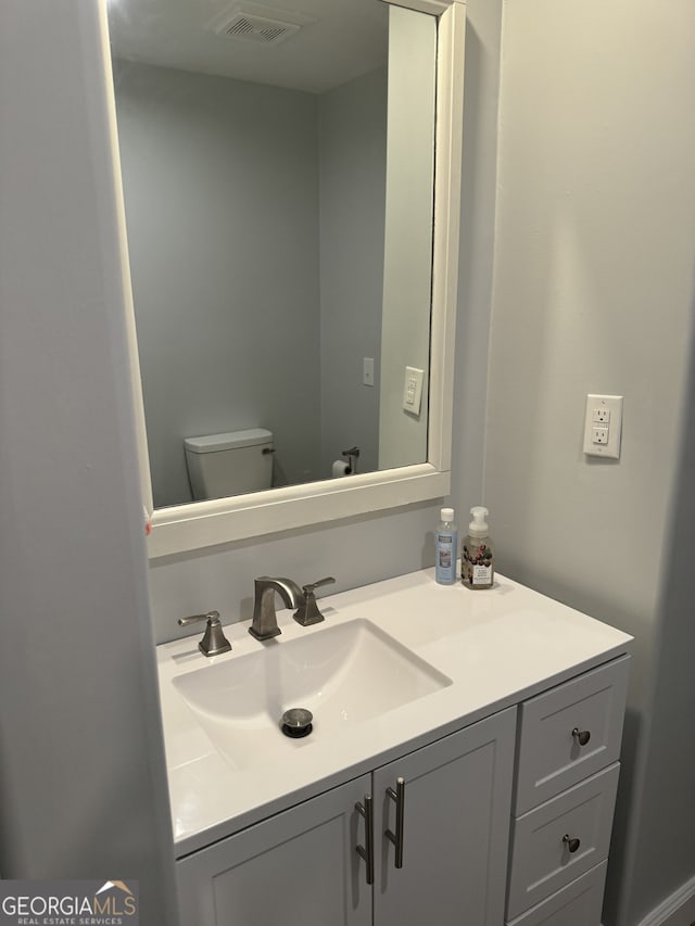 bathroom with toilet and vanity