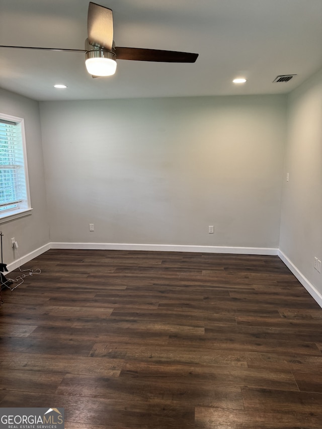 unfurnished room with ceiling fan and dark hardwood / wood-style flooring