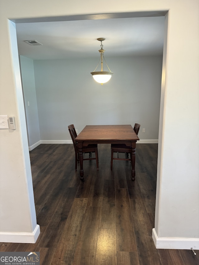 dining space with dark hardwood / wood-style flooring