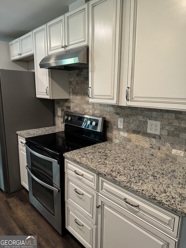 kitchen featuring white cabinets, dark hardwood / wood-style flooring, backsplash, double oven range, and light stone counters