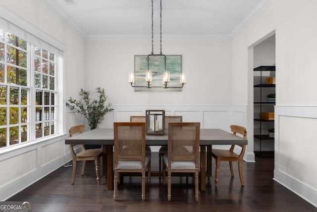 dining area with ornamental molding, dark hardwood / wood-style flooring, and a notable chandelier