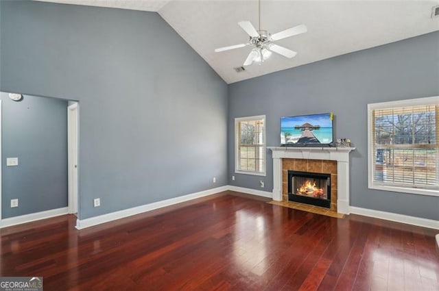 unfurnished living room featuring a fireplace, high vaulted ceiling, ceiling fan, and dark hardwood / wood-style floors