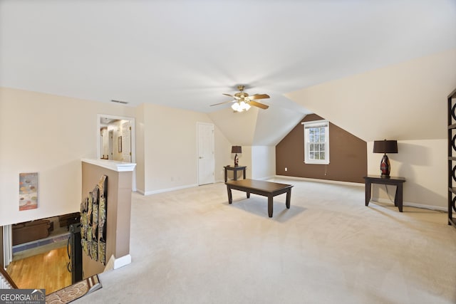 interior space featuring ceiling fan, lofted ceiling, and light carpet