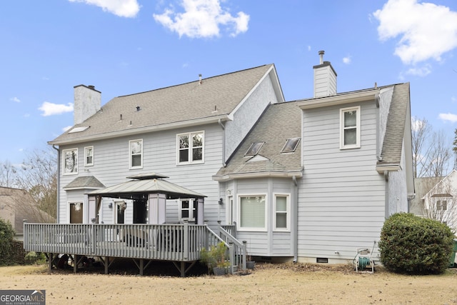 rear view of house with a gazebo and a wooden deck